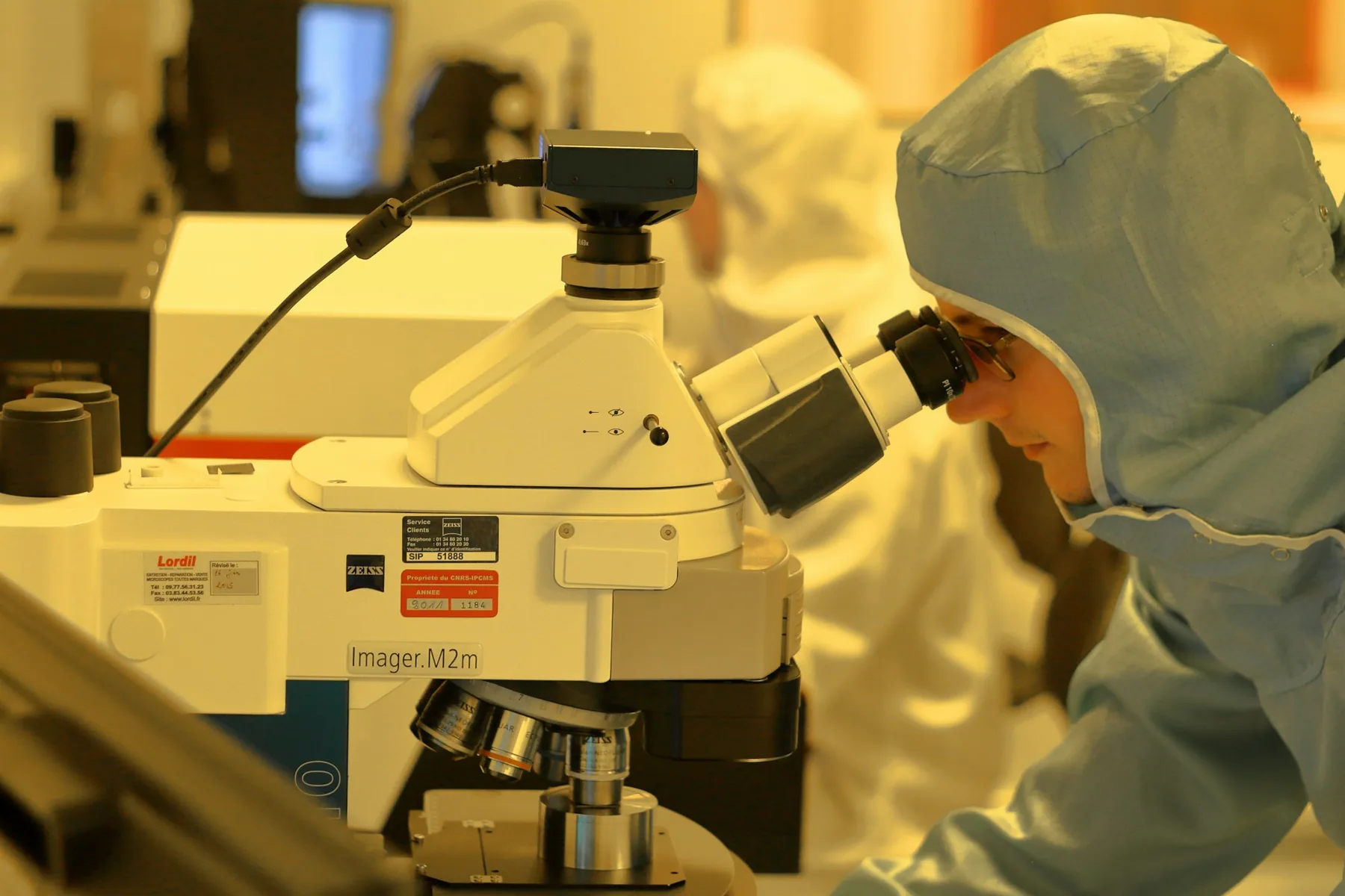 Researcher using precision equipment in a laboratory